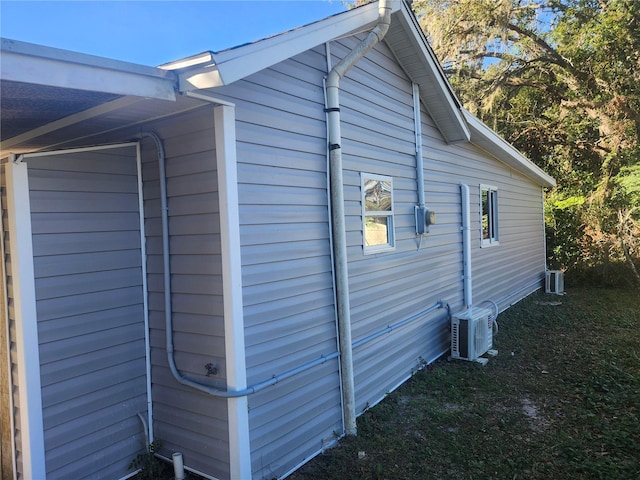 view of side of property with ac unit and central AC unit