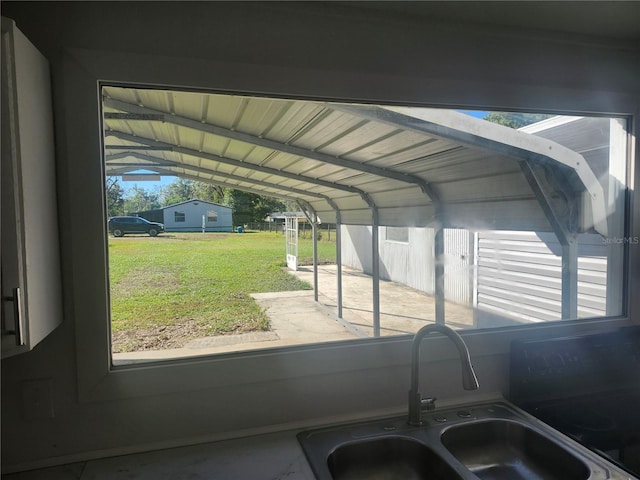 interior space featuring a carport, a lawn, and sink