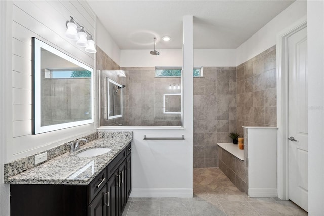 bathroom featuring tile patterned floors, vanity, and tiled shower