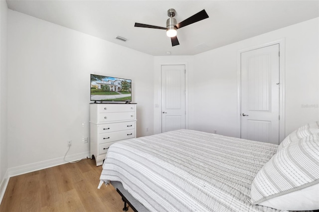 bedroom with ceiling fan and light hardwood / wood-style floors