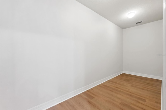 unfurnished room with wood-type flooring