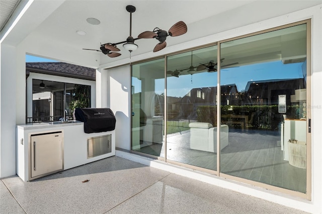 view of patio with grilling area and sink