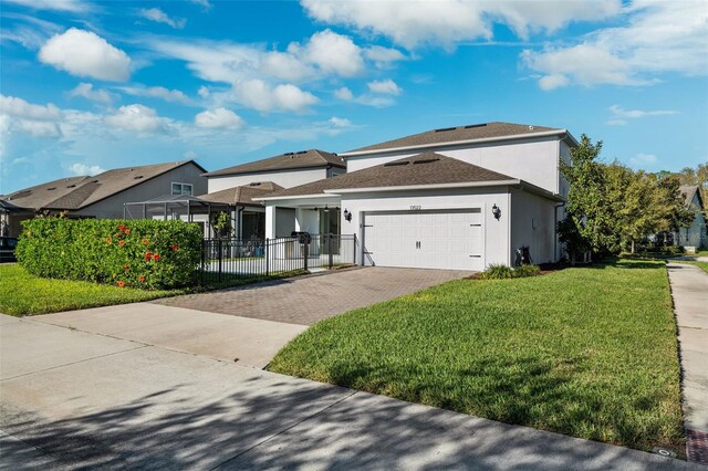 view of front of property featuring a front yard and a garage