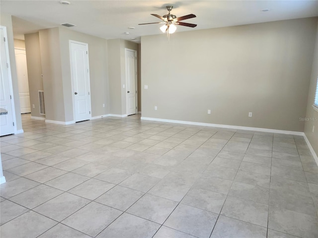 empty room featuring ceiling fan and light tile patterned floors