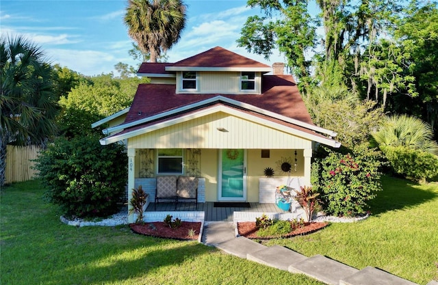 view of front of house with a porch and a front yard