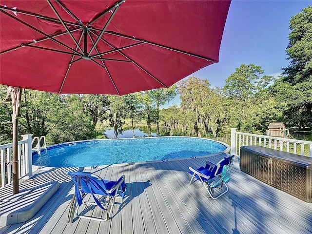 view of swimming pool with a wooden deck