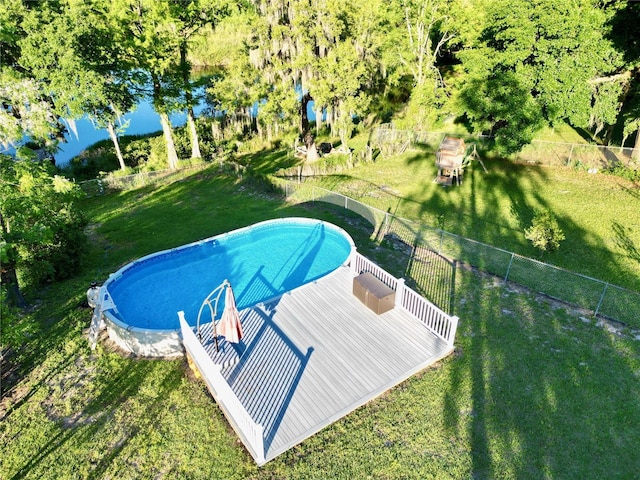 view of pool featuring a lawn and a wooden deck