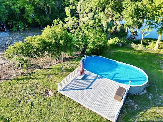 view of swimming pool featuring a lawn