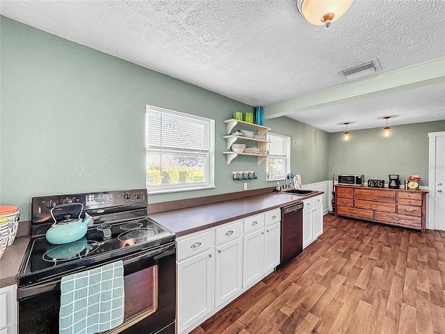 kitchen with white cabinetry, sink, light hardwood / wood-style flooring, a textured ceiling, and black appliances