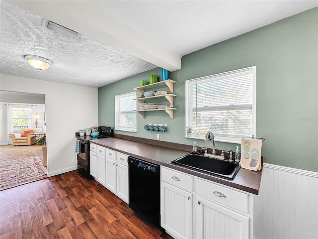 kitchen featuring a healthy amount of sunlight, sink, dark wood-type flooring, black appliances, and white cabinetry