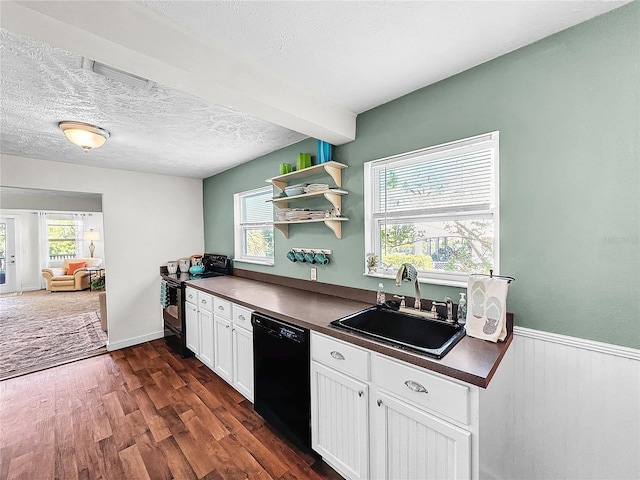 kitchen featuring dark wood-type flooring, black appliances, sink, a wealth of natural light, and white cabinetry