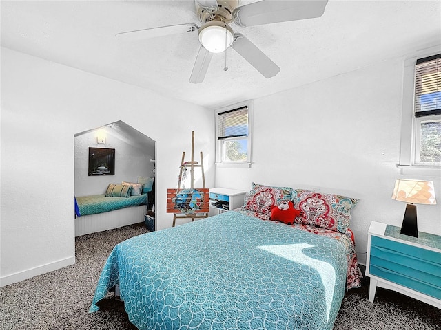 bedroom with carpet, a textured ceiling, and ceiling fan