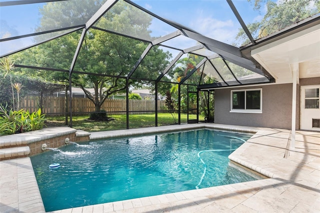 view of pool with pool water feature, a lanai, and a patio