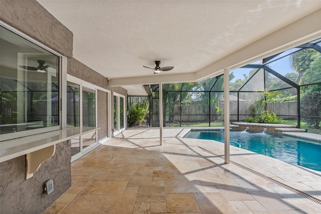 view of swimming pool featuring a lanai, a patio area, pool water feature, and ceiling fan