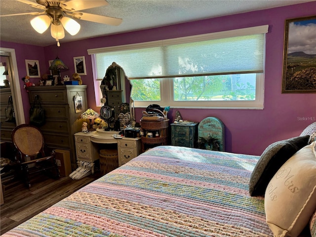 bedroom featuring a textured ceiling, ceiling fan, and dark wood-type flooring