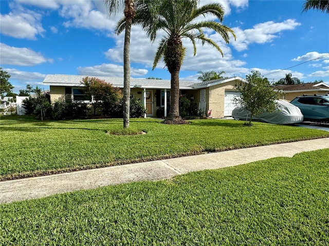 single story home with a front yard and a garage