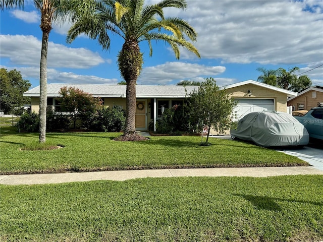 ranch-style home featuring a front lawn and a garage