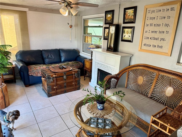 living room featuring ceiling fan and light tile patterned flooring