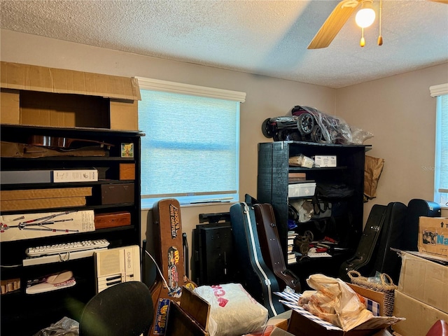 office area featuring a textured ceiling, ceiling fan, and a wealth of natural light