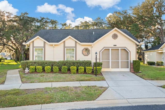 single story home featuring a front lawn and a garage