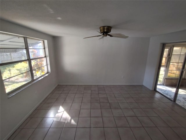 tiled empty room with ceiling fan