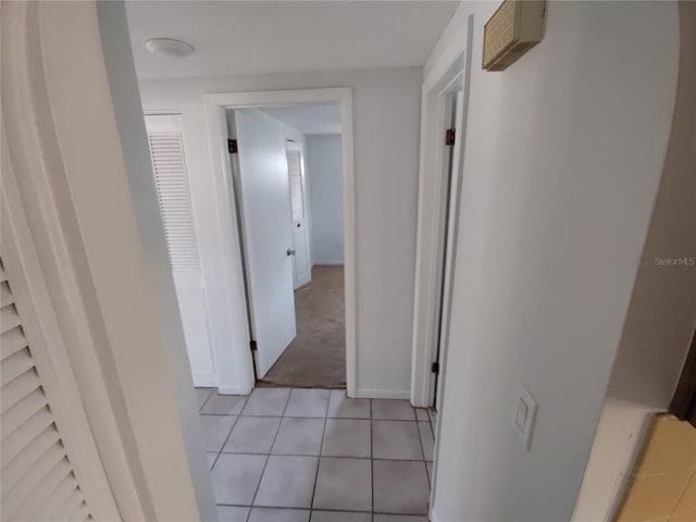 hall featuring light tile patterned floors