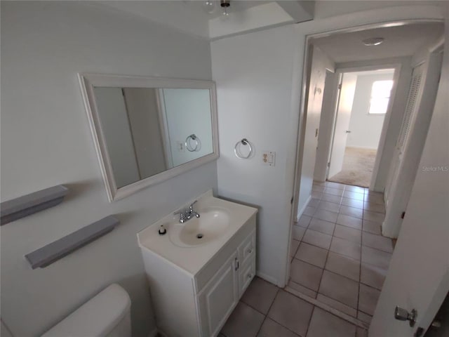 bathroom featuring vanity, toilet, and tile patterned flooring