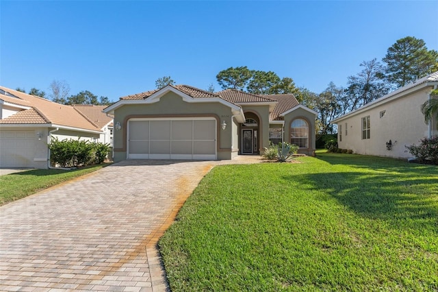 mediterranean / spanish-style house with a garage and a front lawn