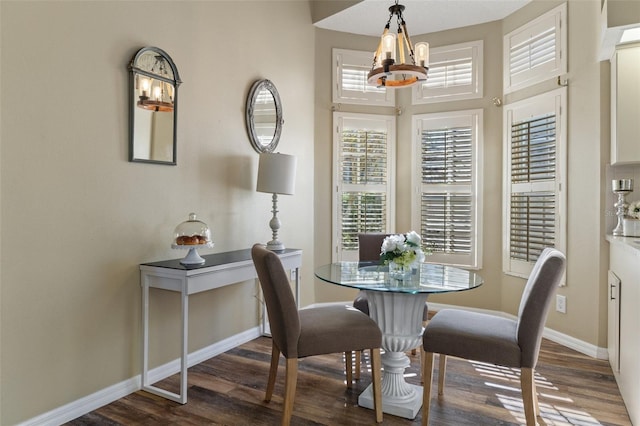 dining space with an inviting chandelier and dark wood-type flooring