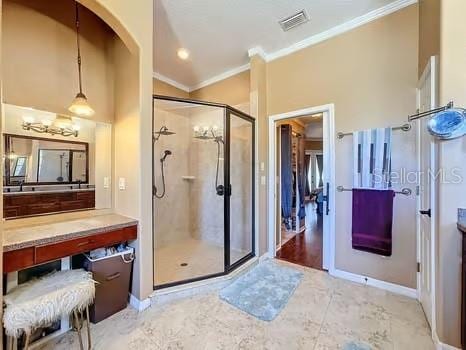 bathroom with vanity, a shower with door, and crown molding