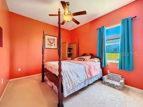 bedroom featuring ceiling fan and carpet