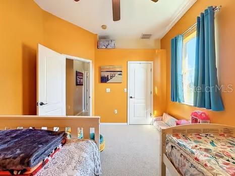 carpeted bedroom with ceiling fan