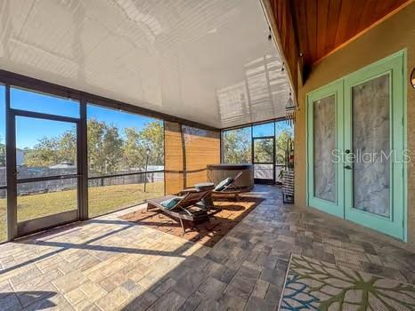 unfurnished sunroom featuring french doors