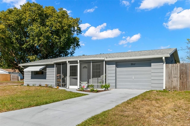 ranch-style home featuring a front yard, a garage, and a sunroom