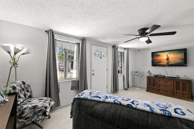 bedroom with ceiling fan and a textured ceiling