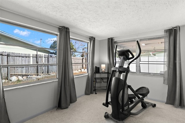 workout room featuring a textured ceiling