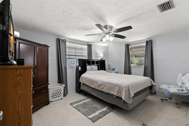 bedroom featuring a textured ceiling and ceiling fan