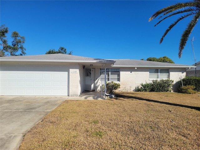 ranch-style home with a garage and a front lawn