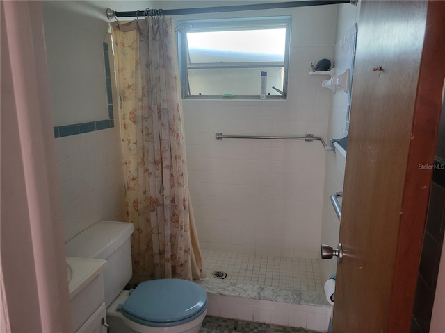 bathroom with tile patterned floors, a shower with curtain, vanity, and toilet