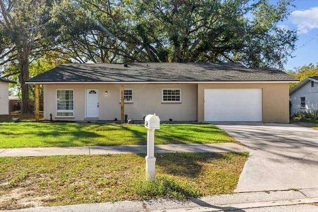 ranch-style house featuring a front yard and a garage