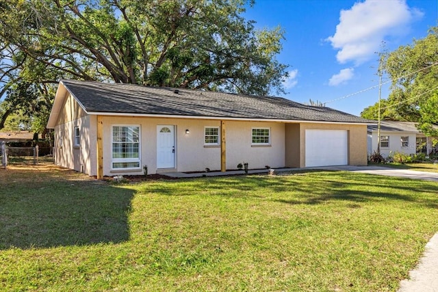 single story home with a garage and a front lawn