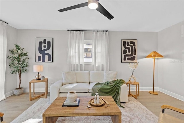 living room with ceiling fan and light hardwood / wood-style floors