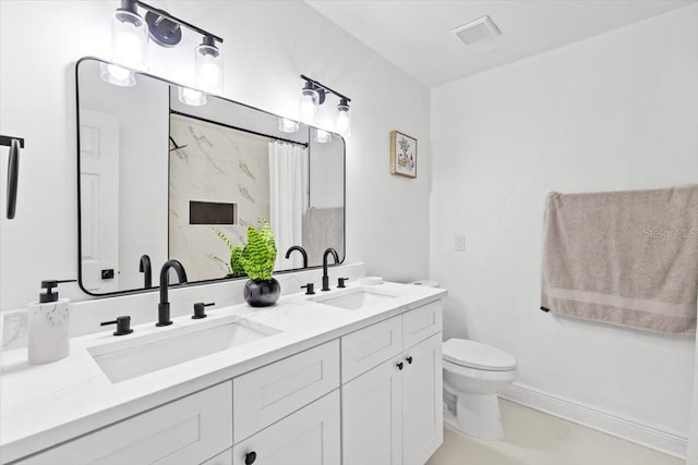 bathroom featuring vanity and toilet