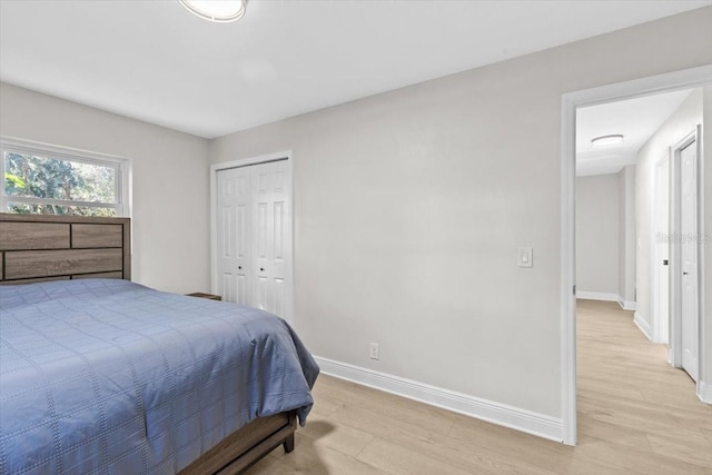 bedroom featuring a closet and light hardwood / wood-style flooring