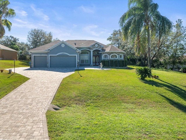 view of front facade with a front yard and a garage