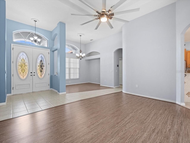 foyer featuring light hardwood / wood-style floors and ceiling fan with notable chandelier