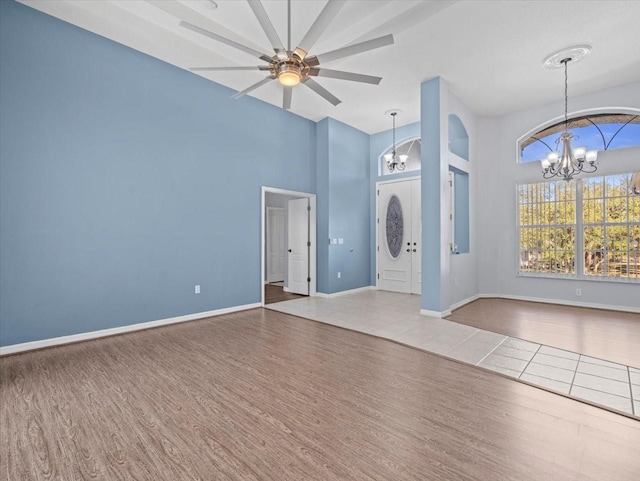 interior space with hardwood / wood-style flooring and ceiling fan with notable chandelier