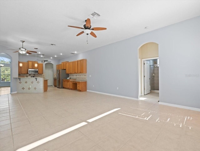 unfurnished living room with ceiling fan and light tile patterned flooring