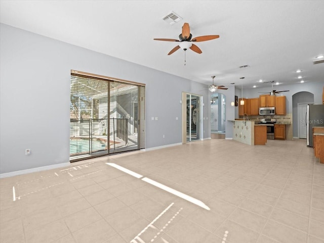 unfurnished living room with light tile patterned flooring and sink