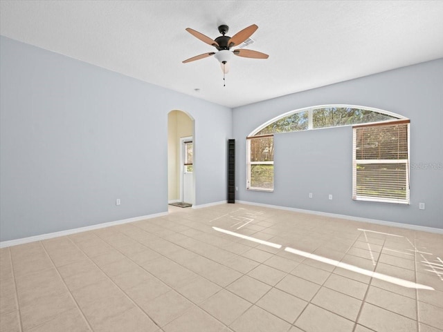 tiled empty room with ceiling fan